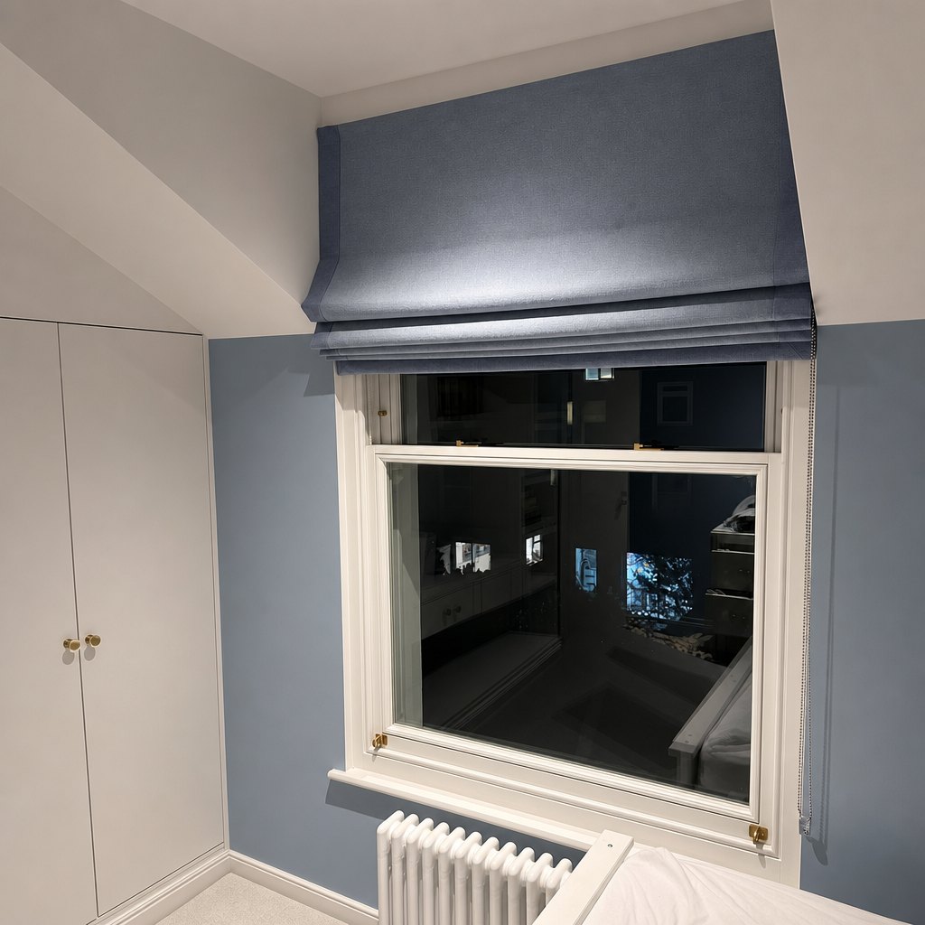 Dark Roman blind above a window