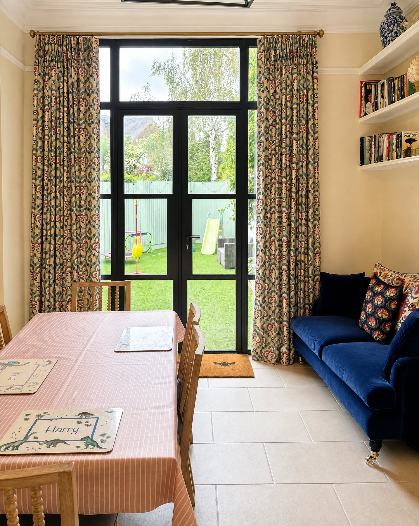 Patterned curtains framing black garden doors