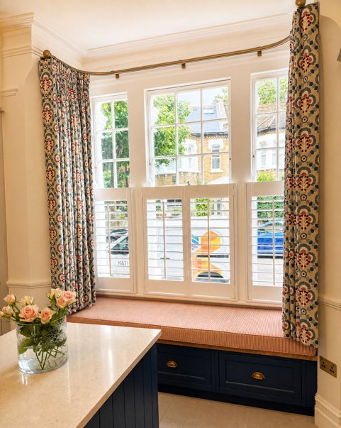 Patterned curtains with white shutters