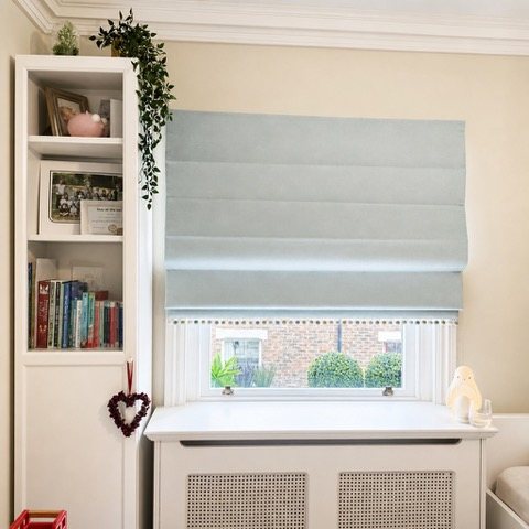 Fabric Roman blind in a soft room setting