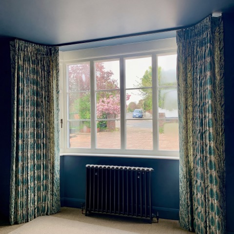 Patterned curtains framing a window